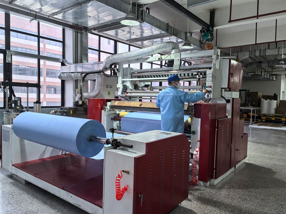 Filter assembly production line with operators in protective uniforms